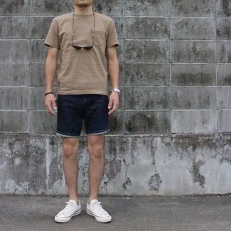 Navy Denim Shorts Outfits For Men: Flaunt your chops in menswear styling by teaming a tan crew-neck t-shirt and navy denim shorts for a relaxed getup. White canvas low top sneakers round off this outfit very nicely.