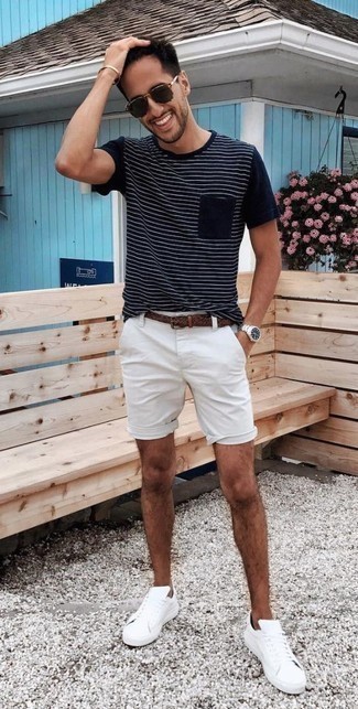 Navy Horizontal Striped Crew-neck T-shirt Outfits For Men: This edgy pairing of a navy horizontal striped crew-neck t-shirt and white shorts is super easy to pull together without a second thought, helping you look seriously stylish and prepared for anything without spending a ton of time digging through your wardrobe. White canvas low top sneakers look amazing here.