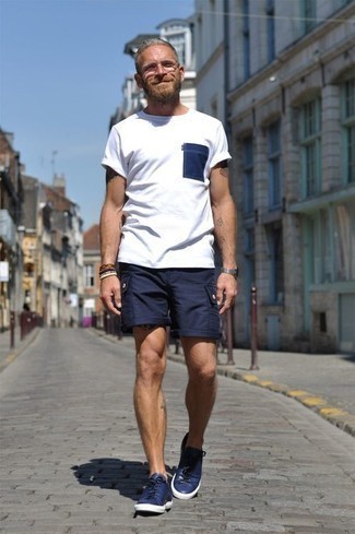 Blue Shorts Outfits For Men: A white and navy crew-neck t-shirt and blue shorts are an easy way to introduce extra cool into your current off-duty rotation. We're totally digging how this whole getup comes together thanks to a pair of navy leather low top sneakers.