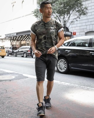 Olive Camouflage Crew-neck T-shirt Outfits For Men: This combo of an olive camouflage crew-neck t-shirt and black denim shorts speaks versatility and effortless menswear style. Let your sartorial expertise really shine by complementing your ensemble with a pair of charcoal canvas low top sneakers.