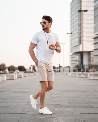 Beige Shorts Outfits For Men: This pairing of a white crew-neck t-shirt and beige shorts is solid proof that a simple casual look doesn't have to be boring. When not sure as to the footwear, add white leather low top sneakers to the mix.