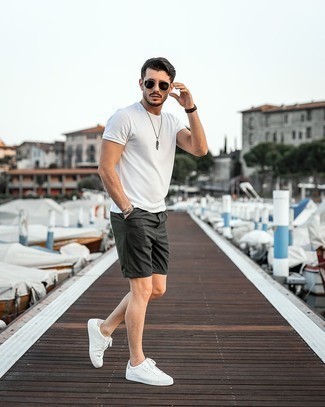 Dark Green Shorts Outfits For Men: This combination of a white crew-neck t-shirt and dark green shorts is hard proof that a pared down casual outfit can still be really interesting. For maximum effect, complement this getup with white leather low top sneakers.