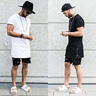 White Leather Sandals Outfits For Men: A white crew-neck t-shirt and black denim shorts are a combo that every style-savvy guy should have in his off-duty arsenal. Introduce a playful feel to with a pair of white leather sandals.