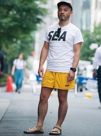 Tan Suede Sandals Outfits For Men: This casual combination of a white and black print crew-neck t-shirt and mustard shorts is perfect when you need to look nice but have zero time. To give this outfit a more relaxed vibe, go for tan suede sandals.