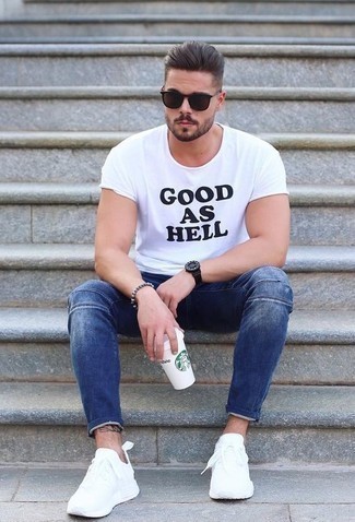 Men's White and Black Print Crew-neck T-shirt, Blue Skinny Jeans, White Athletic Shoes, Dark Brown Sunglasses