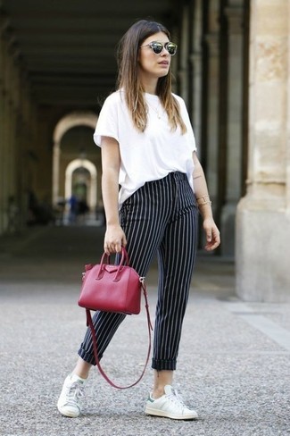 Black Vertical Striped Skinny Pants Outfits: This laid-back combo of a white crew-neck t-shirt and black vertical striped skinny pants is a lifesaver when you need to look great in a flash. Finishing with white leather low top sneakers is a surefire way to infuse an easy-going vibe into your outfit.