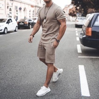 White Athletic Shoes Outfits For Men: This combo of a tan crew-neck t-shirt and tan sports shorts is beyond stylish and provides instant off-duty cool. A pair of white athletic shoes can integrate effortlessly within a multitude of looks.