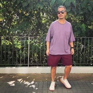 Violet Crew-neck T-shirt Outfits For Men: Such items as a violet crew-neck t-shirt and burgundy sports shorts are the ideal way to infuse extra cool into your casual styling arsenal. Complete this outfit with a pair of white athletic shoes and ta-da: the outfit is complete.