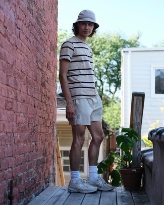 White Bucket Hat Outfits For Men: A white and navy horizontal striped crew-neck t-shirt and a white bucket hat are essential in any guy's functional off-duty collection. A pair of beige athletic shoes easily dials up the wow factor of any getup.