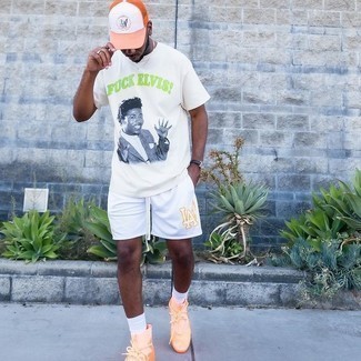 1200+ Hot Weather Outfits For Men: Channel your inner laid-back side and dress in a white print crew-neck t-shirt and white sports shorts. This outfit is complemented wonderfully with a pair of orange athletic shoes.