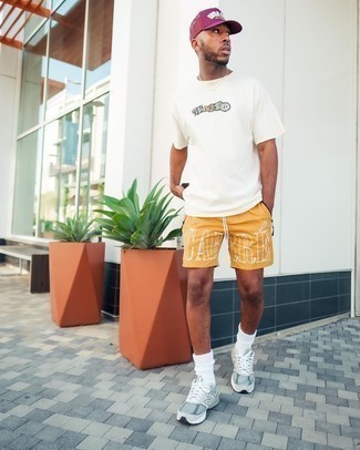 Mustard Sports Shorts Outfits For Men: For a casual outfit with an urban twist, team a white print crew-neck t-shirt with mustard sports shorts. Introduce grey athletic shoes to the equation and you're all done and looking smashing.