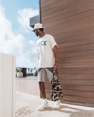 1200+ Hot Weather Outfits For Men: This laid-back pairing of a white and green print crew-neck t-shirt and grey sports shorts is very versatile and apt for whatever the day throws at you. As for footwear, add a pair of white athletic shoes to the mix.