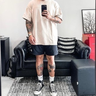 High Top Sneakers Outfits For Men: For a laid-back and cool outfit, opt for a beige crew-neck t-shirt and black sports shorts — these two pieces play nicely together. A pair of high top sneakers looks wonderful complementing your look.