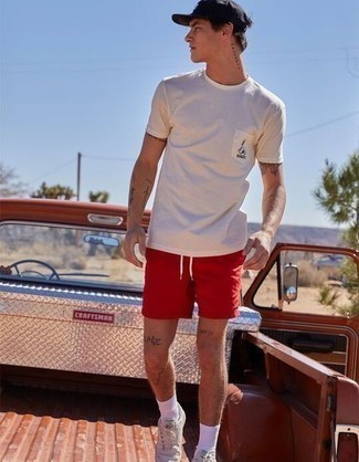 Red Sports Shorts Outfits For Men: A white crew-neck t-shirt and red sports shorts are essential in any gent's great casual sartorial arsenal. Why not take a classic approach with shoes and complement this outfit with white leather low top sneakers?