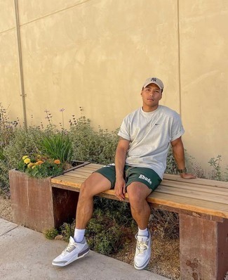 Olive Sports Shorts Outfits For Men: A pulled together off-duty combination of a grey crew-neck t-shirt and olive sports shorts will set you apart instantly. To introduce some extra zing to this getup, complement your look with white leather low top sneakers.