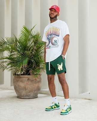 Multi colored Leather Low Top Sneakers Outfits For Men: This combo of a white print crew-neck t-shirt and dark green sports shorts is hard proof that a simple off-duty ensemble doesn't have to be boring. To introduce a bit of depth to this getup, introduce a pair of multi colored leather low top sneakers to the equation.