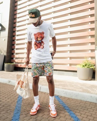 Beige Print Canvas Tote Bag Outfits For Men: Marry a white print crew-neck t-shirt with a beige print canvas tote bag for a laid-back outfit with an edgy spin. To give your overall look a more refined feel, enter orange leather low top sneakers into the equation.