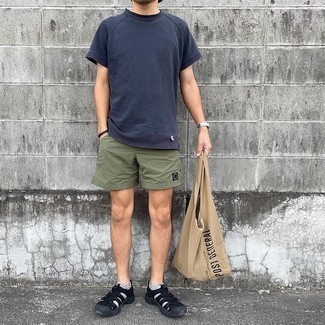 Olive Sports Shorts Outfits For Men: Pair a navy crew-neck t-shirt with olive sports shorts if you're scouting for an outfit idea that speaks urban style. Round off this ensemble with a pair of black canvas sandals to serve a little mix-and-match magic.