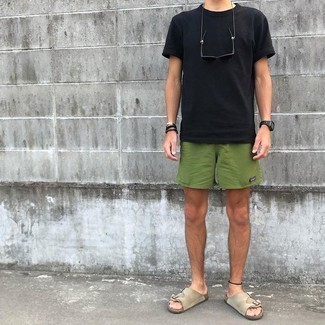 Dark Green Sports Shorts Outfits For Men: Showcase your skills in menswear styling by opting for this modern casual combination of a black crew-neck t-shirt and dark green sports shorts. Dress down your look by wearing a pair of beige suede sandals.