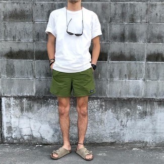 Dark Green Sports Shorts Outfits For Men: This pairing of a white crew-neck t-shirt and dark green sports shorts is hard proof that a straightforward off-duty ensemble can still look incredibly stylish. Clueless about how to finish? Complete your outfit with grey suede sandals to switch things up.