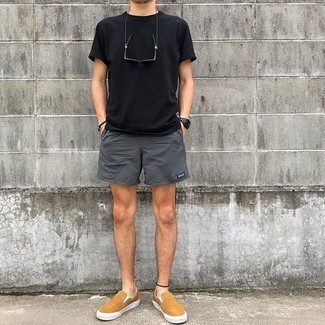 Charcoal Sports Shorts Outfits For Men: Perfect casual street style by opting for a black crew-neck t-shirt and charcoal sports shorts. A pair of tan canvas slip-on sneakers immediately revs up the wow factor of any getup.