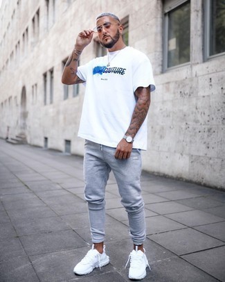 White and Navy Print Crew-neck T-shirt Outfits For Men: For an off-duty ensemble, choose a white and navy print crew-neck t-shirt and grey sweatpants — these two pieces fit perfectly well together. Introduce a pair of white athletic shoes to this look and the whole look will come together.