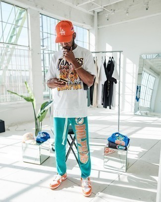 1200+ Hot Weather Outfits For Men: Consider teaming a white print crew-neck t-shirt with aquamarine print sweatpants for a contemporary ensemble that's easy to put together. Finishing off with orange leather low top sneakers is a guaranteed way to bring an added dose of style to your look.