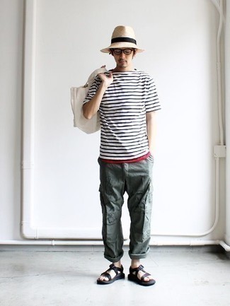 Hat Outfits For Men: Marry a white and navy horizontal striped crew-neck t-shirt with a hat if you want to look neat and relaxed without putting in too much effort. A pair of black canvas sandals can easily dress down a smart outfit.