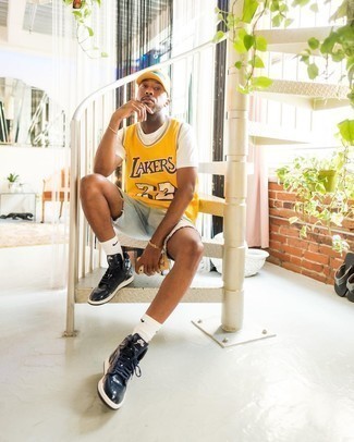 Mustard Print Tank Outfits For Men: The combo of a mustard print tank and light blue denim shorts makes this a solid relaxed outfit. All you need is a pair of navy leather high top sneakers.