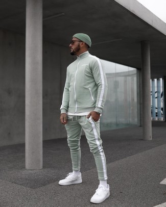 Mint Track Suit Outfits For Men: Such essentials as a mint track suit and a white crew-neck t-shirt are an easy way to infuse subtle dapperness into your day-to-day styling collection. To give this getup a smarter vibe, complement your outfit with a pair of white canvas low top sneakers.