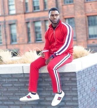 Red and Black Track Suit Outfits For Men: This casual street style pairing of a red and black track suit and a black crew-neck t-shirt is capable of taking on different forms depending on how it's styled. For something more on the smart side to complete this look, throw in white print leather low top sneakers.