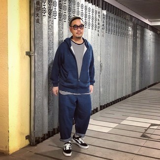 Navy Track Suit Outfits For Men: This laid-back combo of a navy track suit and a white and black horizontal striped crew-neck t-shirt is extremely versatile and really apt for whatever the day throws at you. If you want to effortlessly kick up your getup with one single item, add a pair of black and white canvas low top sneakers to the mix.
