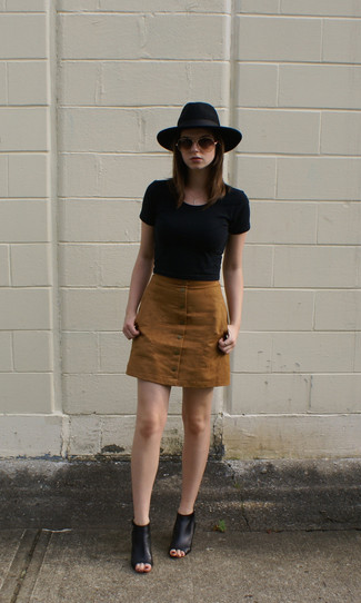 Brown Denim Mini Skirt Outfits: This pairing of a black cropped top and a brown denim mini skirt is ideal when you need to go about your day with confidence in your look. Tone down the casualness of your ensemble by wearing black leather mules.