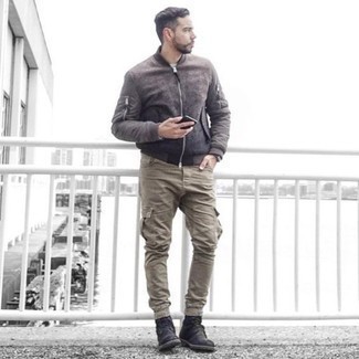 Dark Brown Bomber Jacket Outfits For Men: A dark brown bomber jacket and khaki cargo pants? This is easily a wearable ensemble that you can rock a version of on a day-to-day basis. Rounding off with a pair of black suede casual boots is the simplest way to breathe an element of elegance into this outfit.