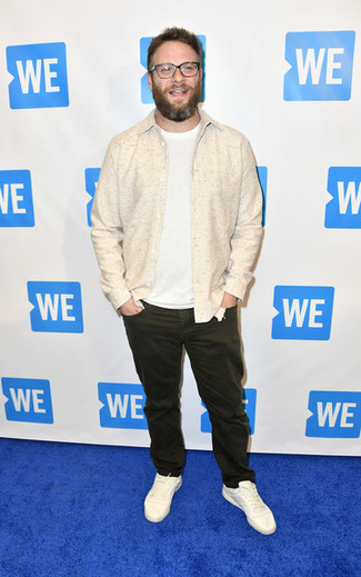 Seth Rogen wearing White Leather Low Top Sneakers, Dark Brown Jeans, White Crew-neck T-shirt, Beige Shirt Jacket