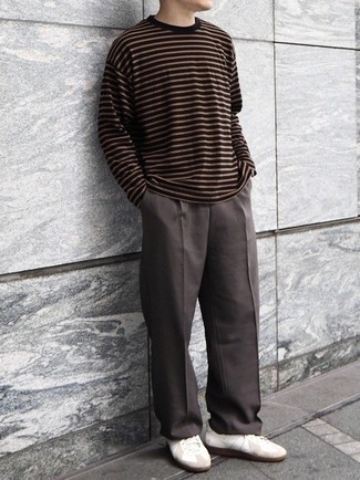 Dark Brown Long Sleeve T-Shirt Outfits For Men: You'll be surprised at how easy it is for any gentleman to throw together this casual look. Just a dark brown long sleeve t-shirt and dark brown chinos. If you're on the fence about how to finish, add white leather low top sneakers to the equation.
