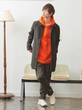 Orange Hoodie Outfits For Men: Choose an orange hoodie and dark brown sweatpants to get a contemporary and stylish ensemble. Beige athletic shoes look right at home with this ensemble.