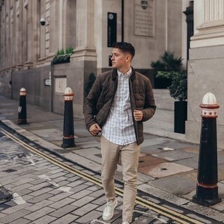 Brown Quilted Shirt Jacket Outfits For Men: For a goofproof casual option, you can always rely on this pairing of a brown quilted shirt jacket and beige jeans. Dress down this ensemble by wearing white canvas low top sneakers.
