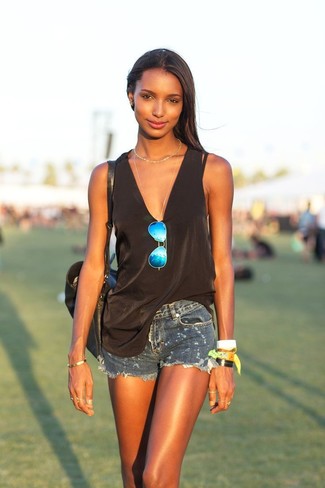 Dark Brown Sleeveless Top Outfits: For comfort dressing with a modern twist, you can easily opt for a dark brown sleeveless top and navy ripped denim shorts.