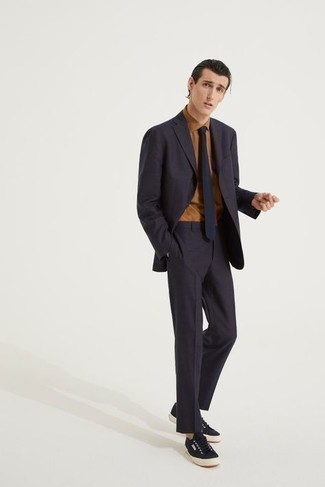 Dark Brown Suit Outfits: You're looking at the solid proof that a dark brown suit and a tan dress shirt look amazing when you team them together in a sophisticated look for a modern man. Introduce a hint of stylish effortlessness to by rocking black canvas low top sneakers.