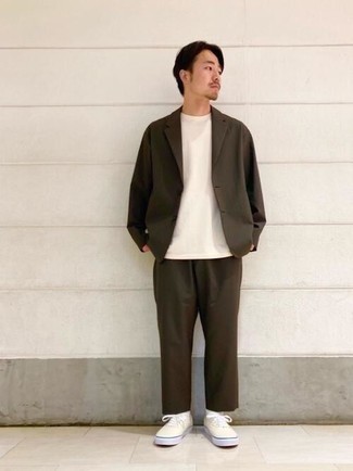 Dark Brown Suit Outfits: This combination of a dark brown suit and a white crew-neck t-shirt is the perfect base for a multitude of effortlessly refined getups. Let your styling credentials truly shine by complementing your ensemble with a pair of beige canvas low top sneakers.