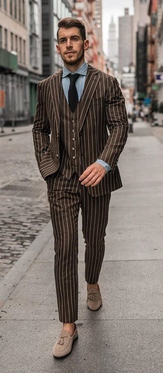Dark Brown Three Piece Suit Outfits: This combination of a dark brown three piece suit and a light blue chambray dress shirt is incredibly dapper and provides a clean and chic look. For something more on the cool and casual side to complete this look, introduce beige suede tassel loafers to your ensemble.