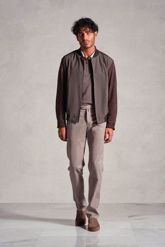 Tobacco Chinos Outfits: If it's ease and functionality that you appreciate in menswear, go for a dark brown varsity jacket and tobacco chinos. Complement this look with a pair of brown suede loafers to easily kick up the fashion factor of your look.
