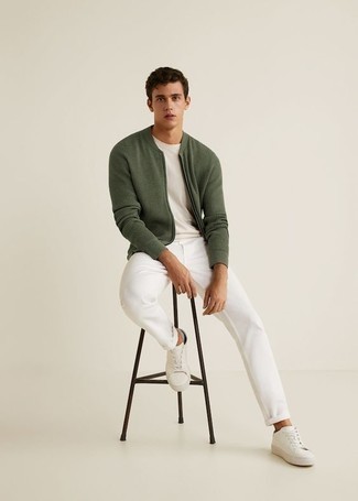 Olive Bomber Jacket Outfits For Men: An olive bomber jacket and white chinos worn together are the perfect look for those dressers who appreciate casual styles. Finish your outfit with a pair of white leather low top sneakers to serve a little outfit-mixing magic.