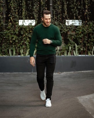 Dark Green Crew-neck Sweater Outfits For Men: This off-duty combination of a dark green crew-neck sweater and black jeans is a never-failing option when you need to look good but have no time to pull together a look. Complete your getup with white canvas low top sneakers and ta-da: your look is complete.