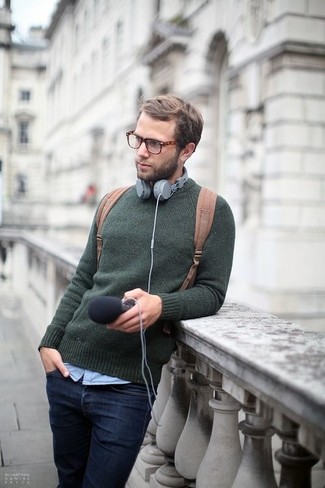 Beige Canvas Backpack Outfits For Men: This urban combination of a dark green crew-neck sweater and a beige canvas backpack is very easy to put together without a second thought, helping you look amazing and ready for anything without spending a ton of time searching through your closet.
