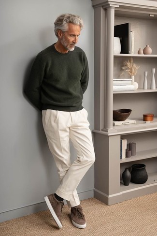 Men's Outfits 2022: A dark green crew-neck sweater and white chinos are a good getup worth incorporating into your current casual collection. Have some fun with things and complete your outfit with a pair of dark brown suede low top sneakers.