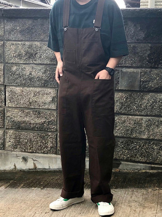 Overalls Outfits For Men: We all seek practicality when it comes to fashion, and this urban pairing of a dark green horizontal striped crew-neck t-shirt and overalls is a great example of that. Complete this ensemble with white and green canvas low top sneakers for a touch of refinement.