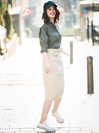 Olive Dress Shirt Outfits For Women: One of our favorite ways to style out such a must-have piece as an olive dress shirt is to pair it with a beige pencil skirt. Inject a mellow feel into this look with white canvas low top sneakers.