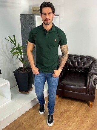 Men's Outfits 2022: For comfort dressing with a modern take, rock a dark green polo with blue jeans. A cool pair of black leather slip-on sneakers ties this ensemble together.